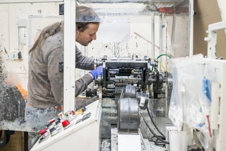 A man working on a machine in a factory.