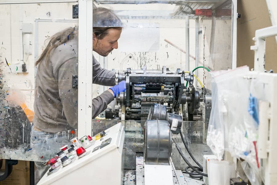 A man working on a machine during a commercial factory photography shoot