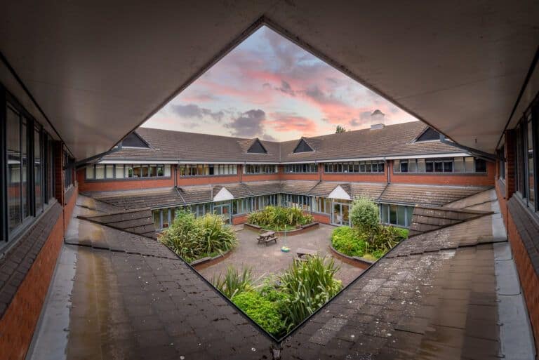 A view of a courtyard from a window in a building.