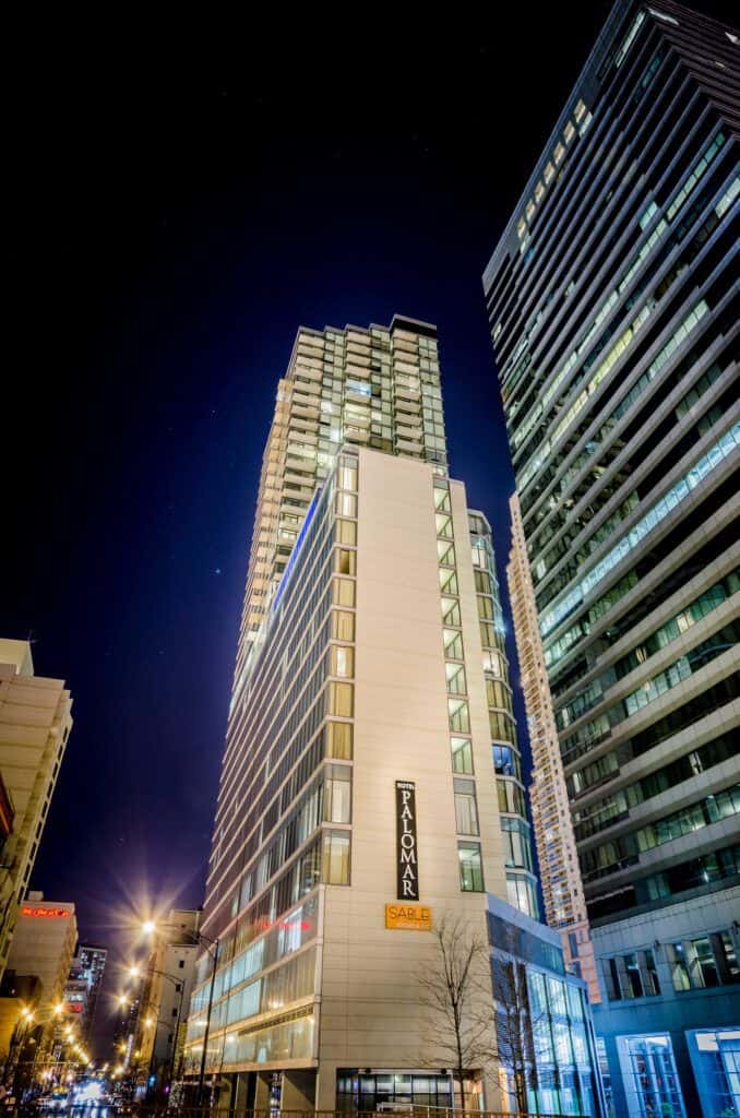A tall building is lit up at night.
