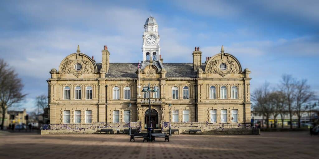 A large building with a clock tower in the middle.