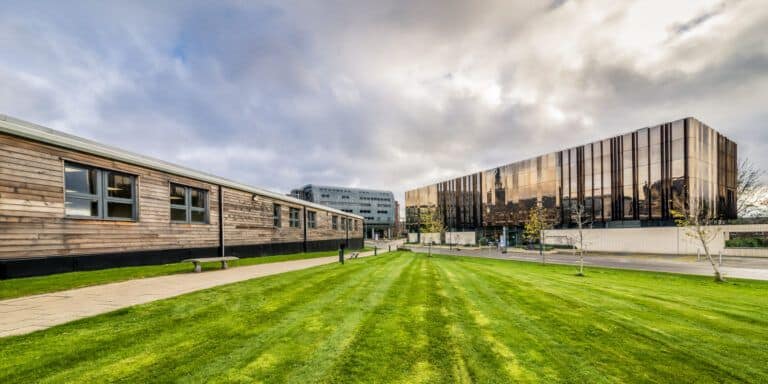 A building with a grassy lawn in front of it.