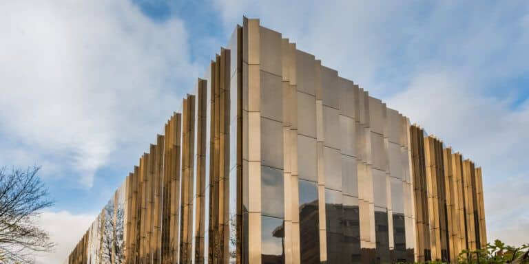 A building with a golden facade on the side of a street.