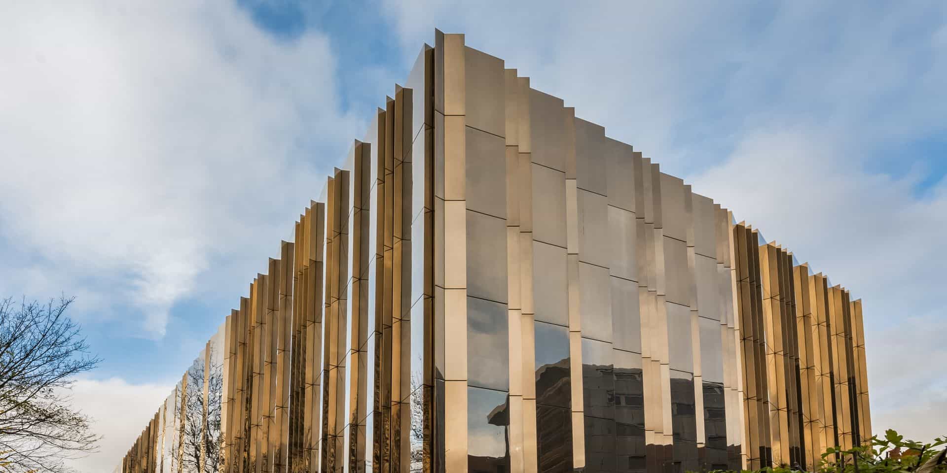 A building with a golden facade on the side of a street.