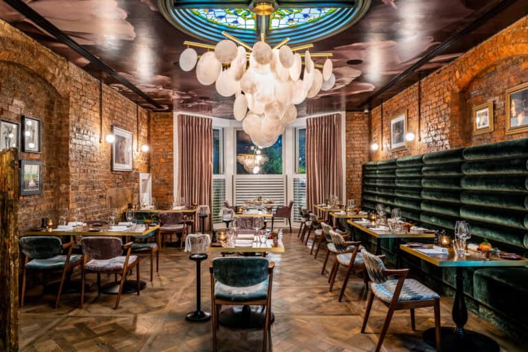The interior of a restaurant with a chandelier hanging from the ceiling.