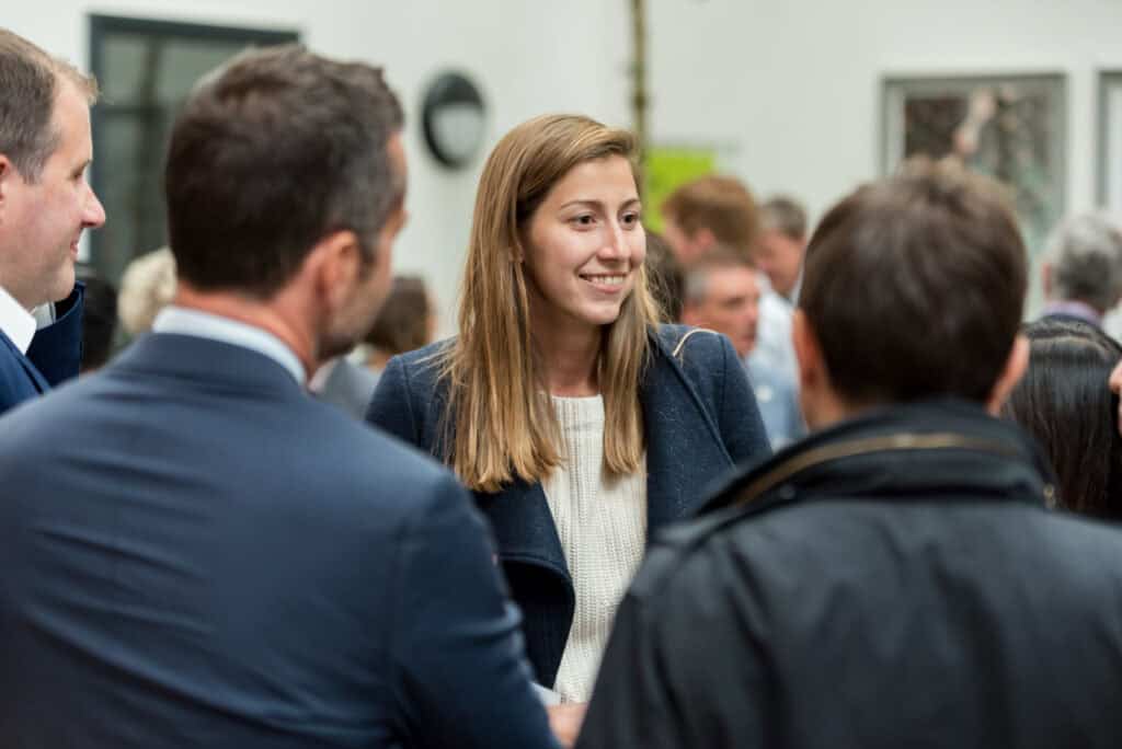 A group of people talking to each other at an event.