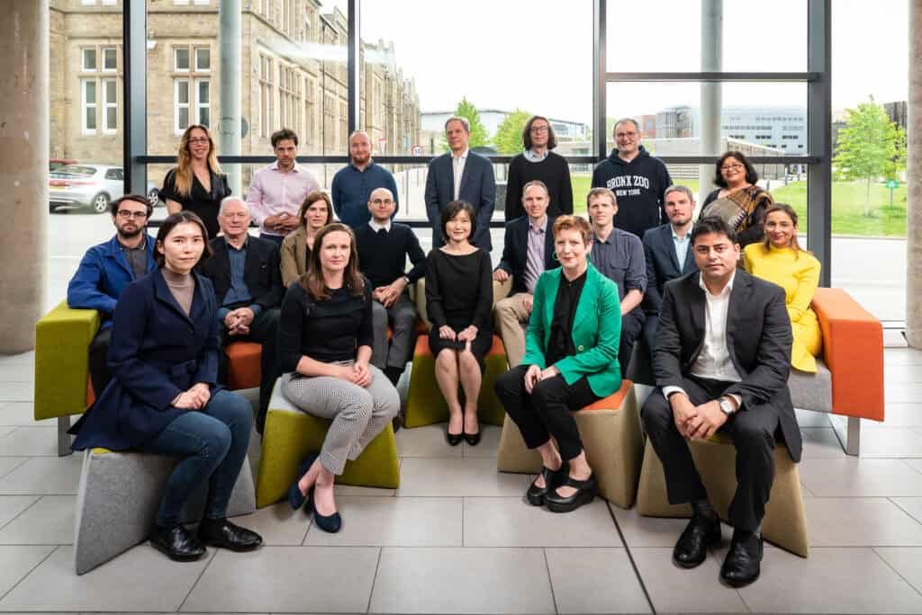 A group of people posing for a photo in an office.
