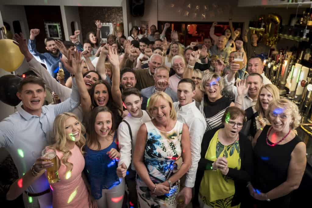 A group of people posing for a photo at a party.