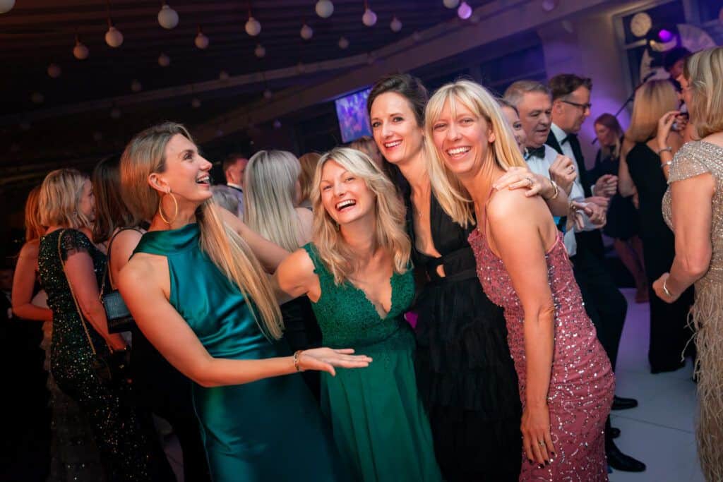 A group of women posing for a photo at a party.