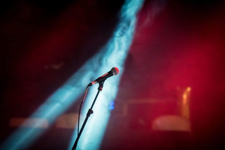 A microphone in front of a red and blue light.