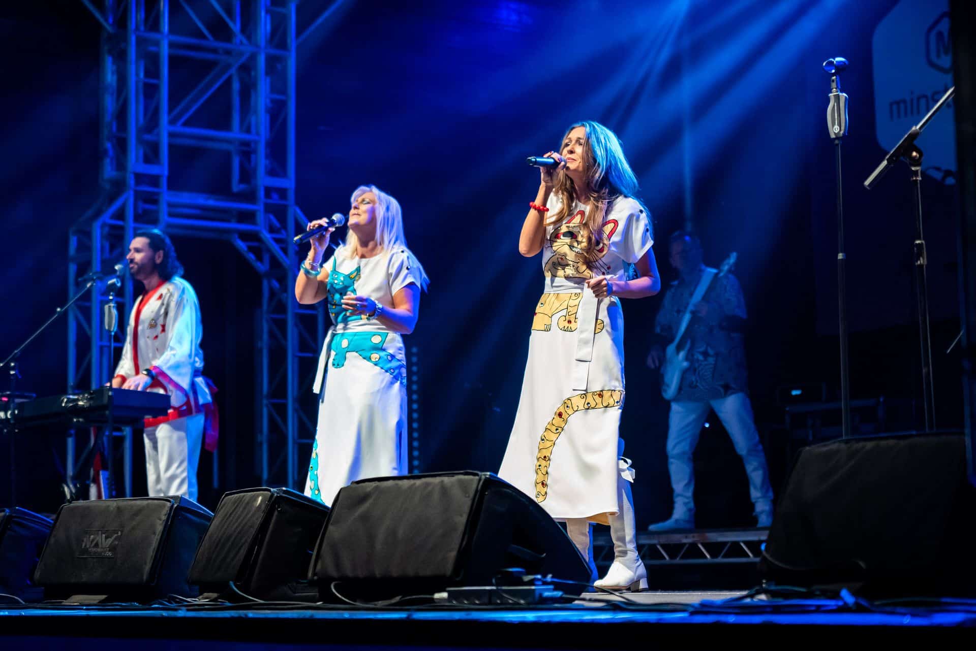 A group of people singing on stage at a concert.