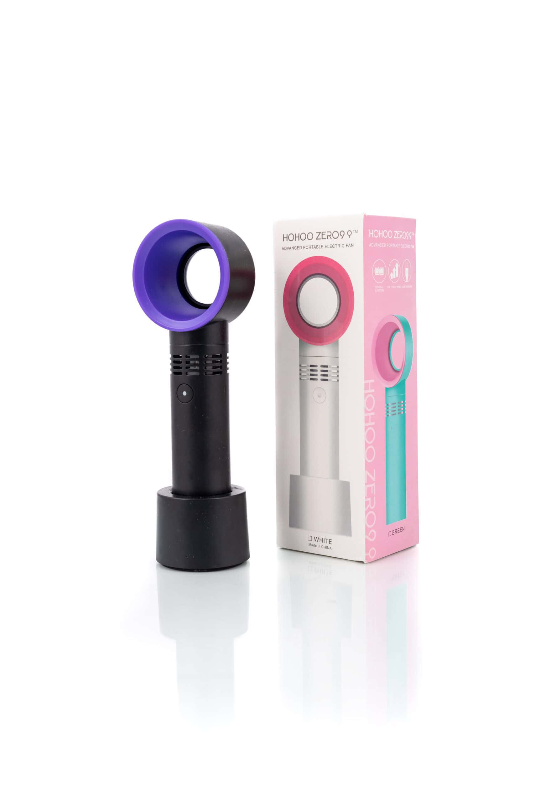 A pink and purple hair dryer in front of a box.