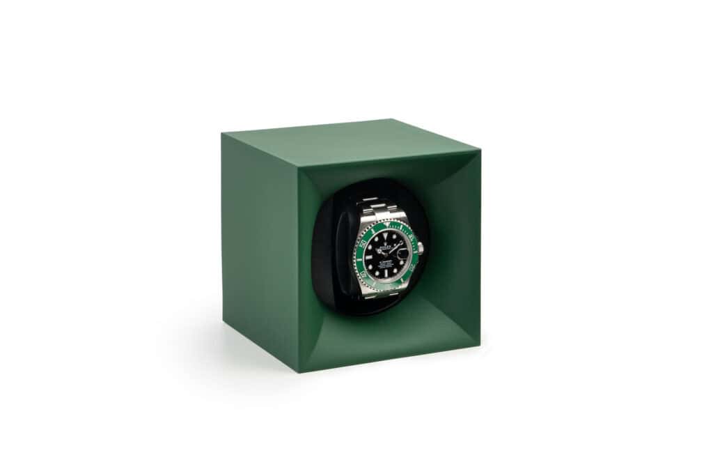 A rolex watch in a green box.
