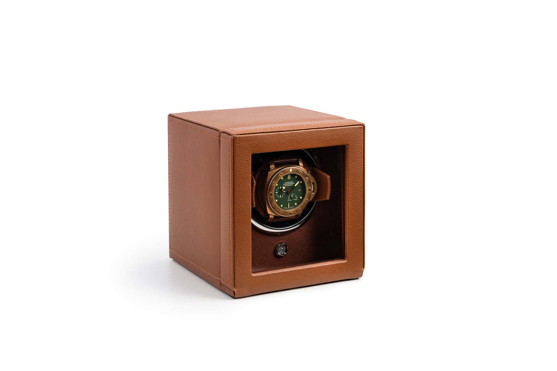 A watch winder in a brown box.